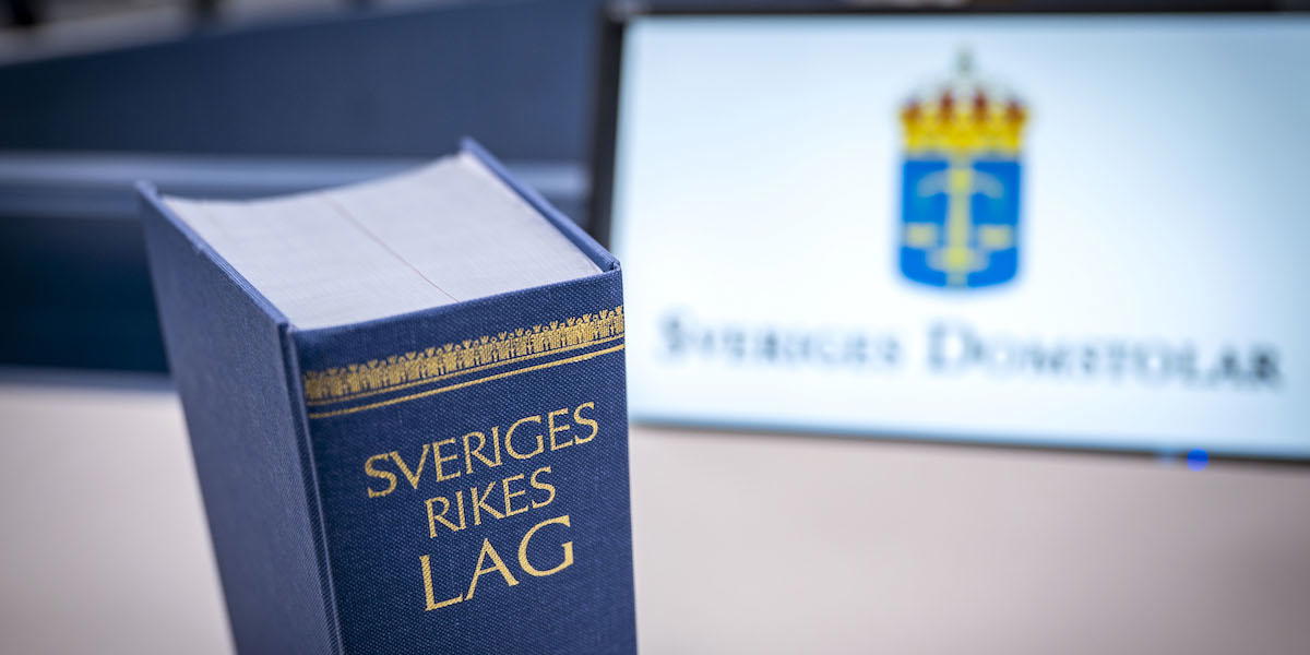 Boken Sveriges rikes lag i en sal i Helsingborgs tingsrätt. En banktjänstemannen kom över en miljon kronor från 137 dödsbon innan han avslöjades, nu åtalas han för 15 av fallen.