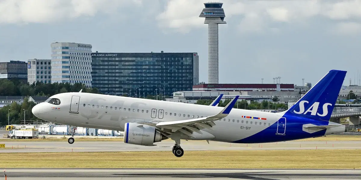 Ett flygplan från SAS landar på Arlanda flygplats. Vissa flygbolag har börjat ta bort sina bränsletillägg, vilket innebär lägre flygpriser för resenärerna.